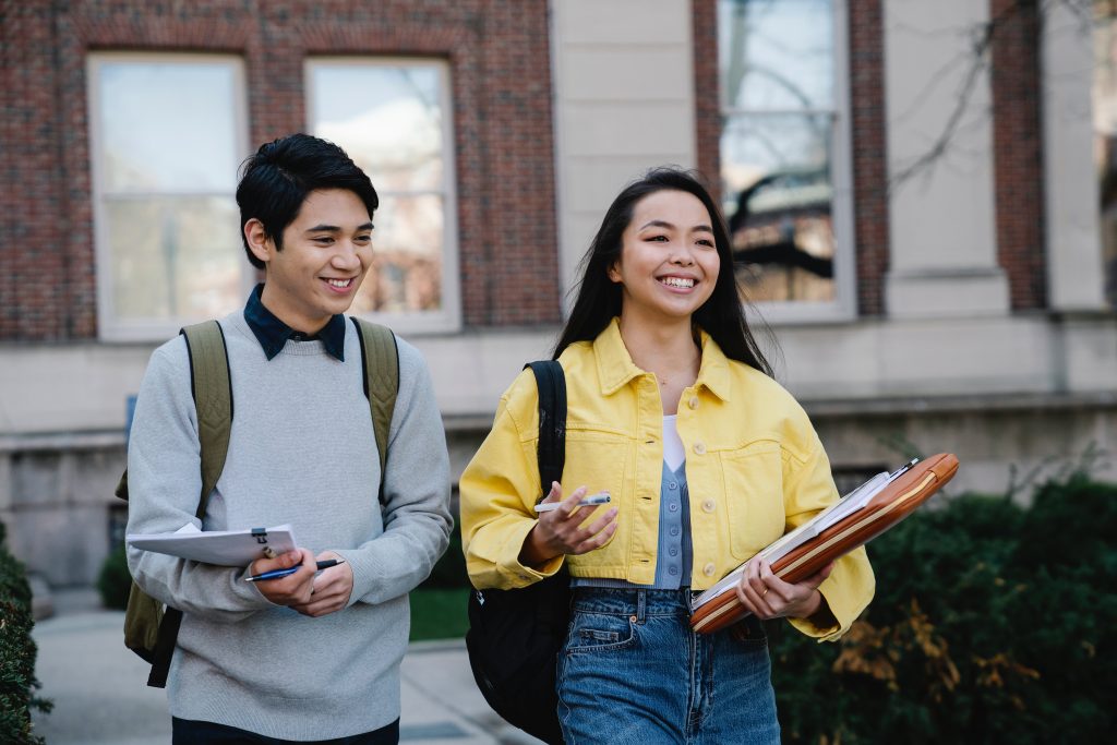 Group of university friends having a cheerful discussion on campus.