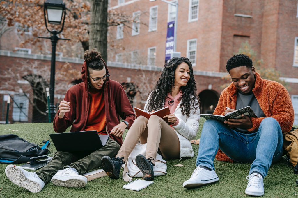 Group of university friends having a lively outdoor discussion on campus.