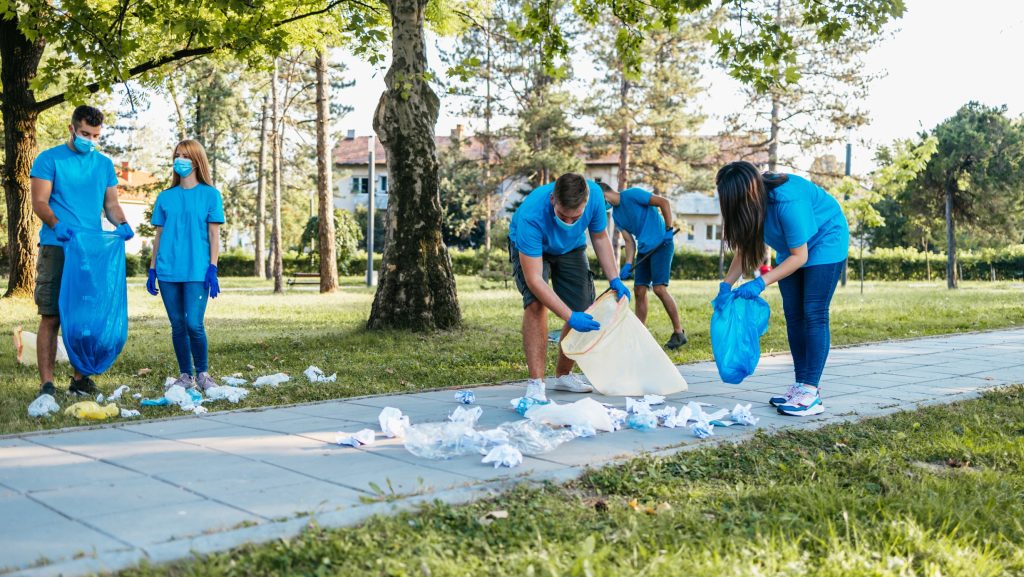 University students working together to clean the streets as part of a community service activity.